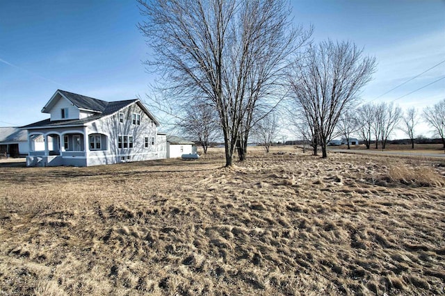 view of side of home featuring an outdoor structure