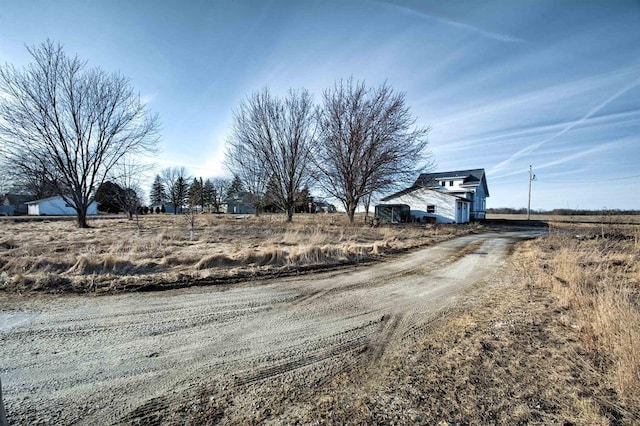 view of street with dirt driveway