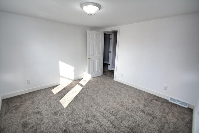 unfurnished room with visible vents, baseboards, and carpet flooring