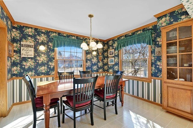 dining space with wallpapered walls, a notable chandelier, baseboards, and ornamental molding