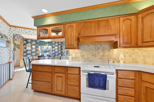 kitchen with wallpapered walls, brown cabinetry, and electric stove