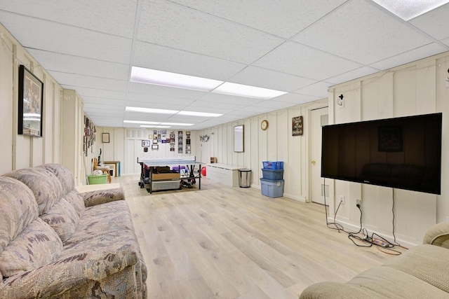 living room with light wood-style floors and a paneled ceiling