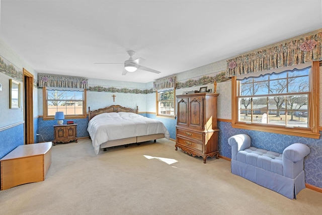 bedroom featuring multiple windows, carpet floors, ceiling fan, and wallpapered walls