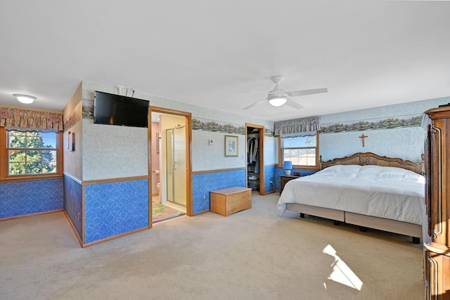 unfurnished bedroom with wallpapered walls, carpet flooring, baseboards, and ceiling fan