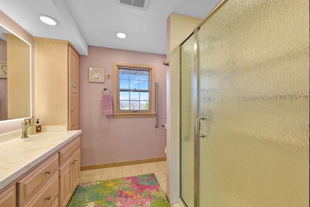 bathroom featuring visible vents, a shower stall, tile patterned flooring, baseboards, and vanity