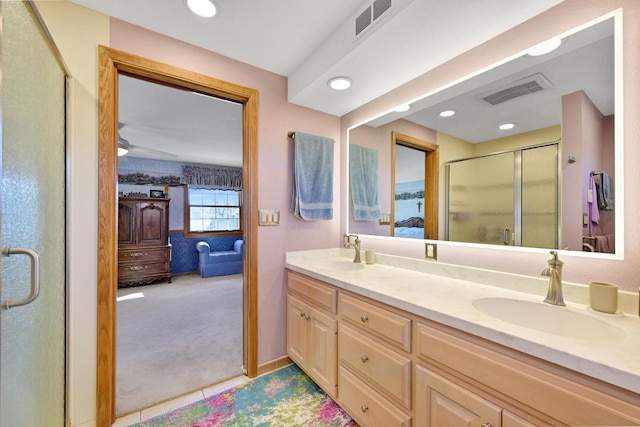 ensuite bathroom with visible vents, a shower stall, ensuite bathroom, and a sink