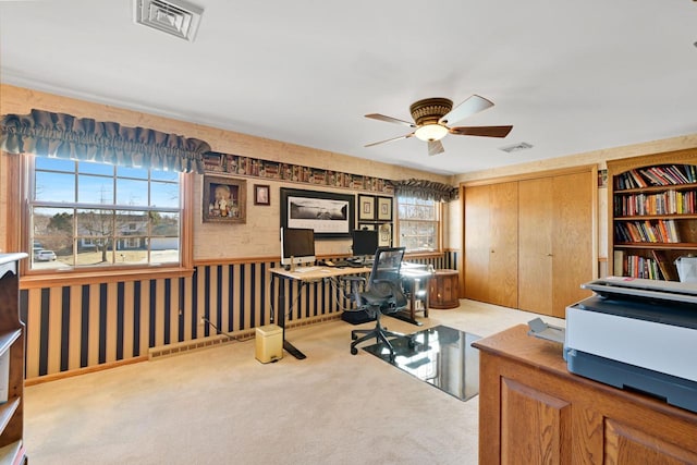 home office featuring wallpapered walls, visible vents, a wealth of natural light, and carpet floors