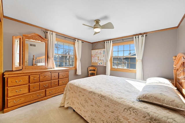 bedroom featuring visible vents, multiple windows, light colored carpet, and ornamental molding