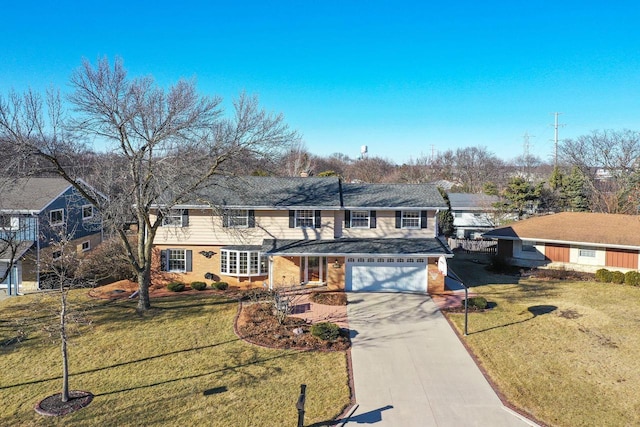 traditional-style home featuring an attached garage, concrete driveway, and a front yard