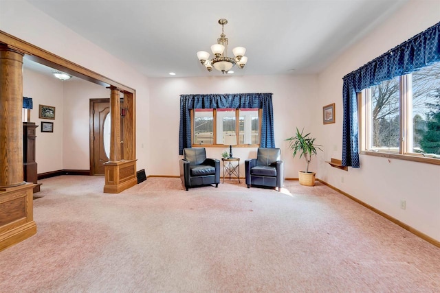 sitting room with carpet flooring, an inviting chandelier, decorative columns, and baseboards