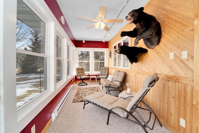 sunroom / solarium with a ceiling fan and a baseboard radiator