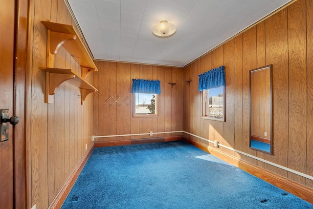 spare room featuring baseboards and carpet floors