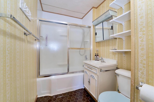 bathroom with toilet, ornamental molding, tile patterned floors, combined bath / shower with glass door, and vanity