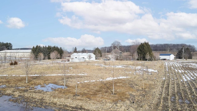 view of yard with an outdoor structure and a rural view