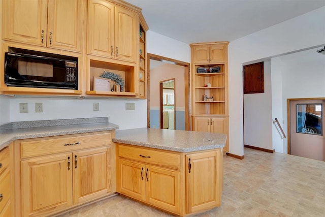 kitchen with open shelves, separate washer and dryer, black microwave, and light brown cabinetry