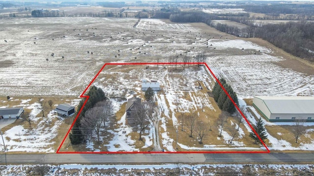 snowy aerial view featuring a rural view