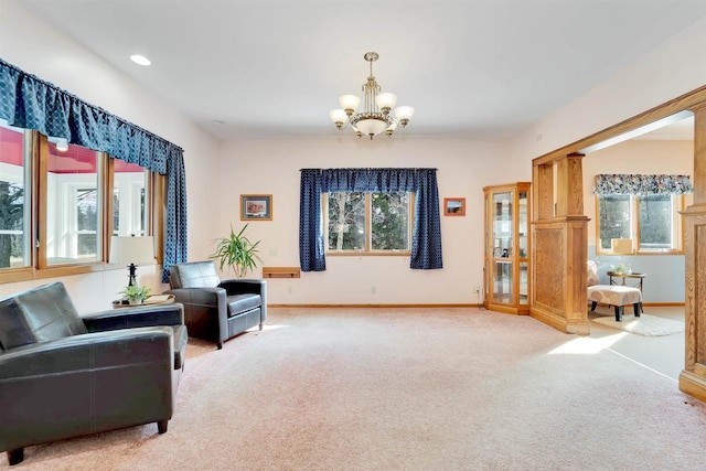 living area with recessed lighting, baseboards, light carpet, and an inviting chandelier