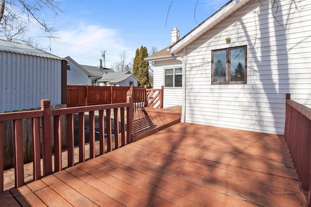 wooden terrace featuring fence