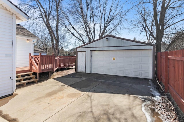 detached garage featuring fence