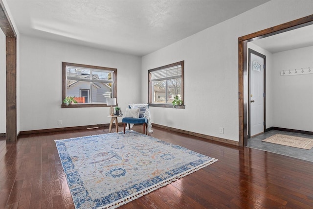 sitting room with hardwood / wood-style floors and baseboards