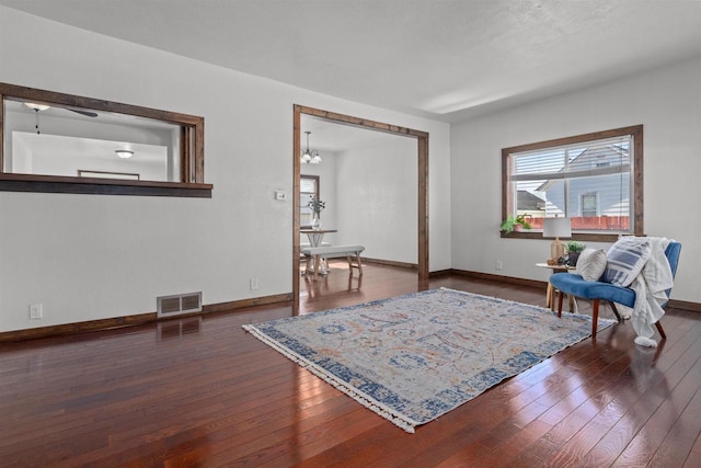 sitting room featuring visible vents, baseboards, and hardwood / wood-style floors