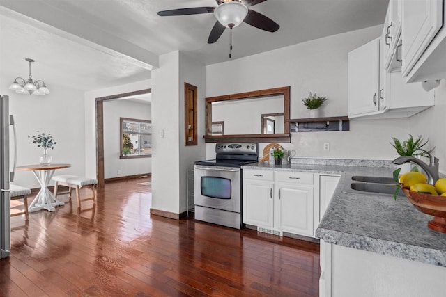 kitchen featuring a sink, appliances with stainless steel finishes, white cabinets, light countertops, and dark wood-style flooring