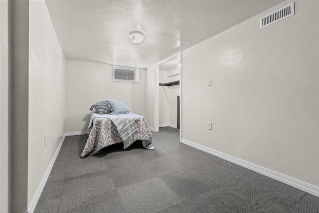 bedroom with baseboards and visible vents