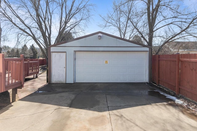 detached garage featuring fence