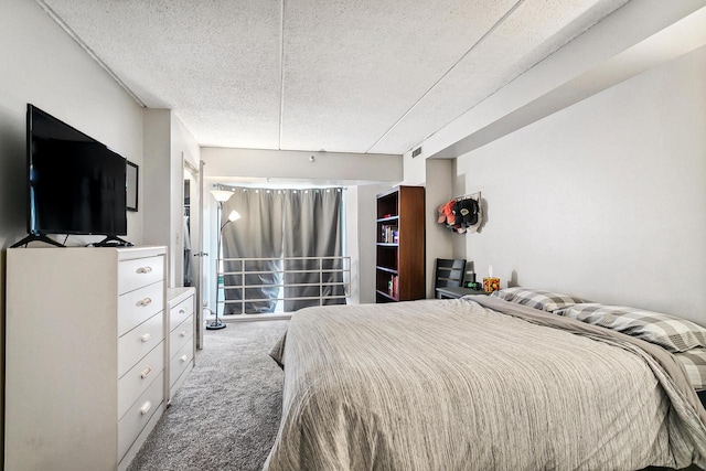 carpeted bedroom featuring a textured ceiling