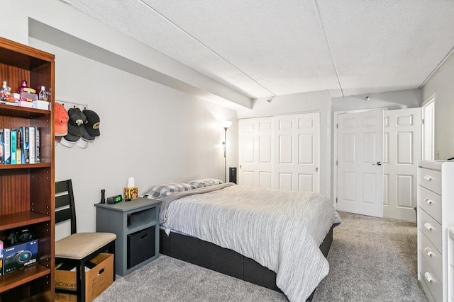 carpeted bedroom featuring a closet and a textured ceiling