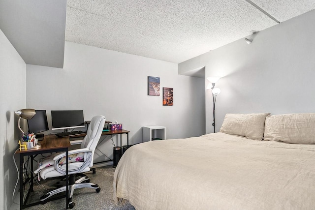 bedroom with a textured ceiling and carpet