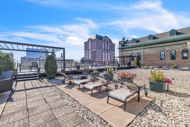 view of patio / terrace featuring a view of city and a pergola