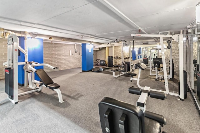 exercise room with brick wall