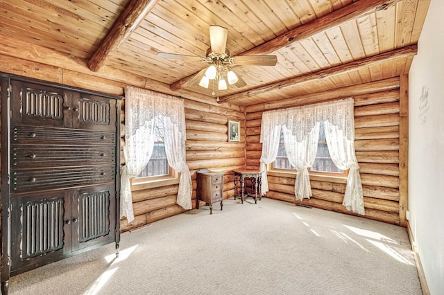 unfurnished room featuring beam ceiling, ceiling fan, and wooden ceiling