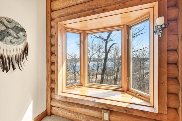 room details featuring rustic walls and baseboards