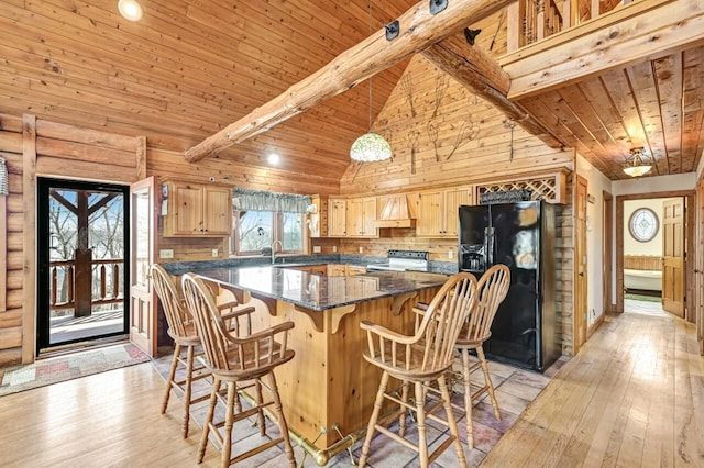 kitchen featuring light brown cabinetry, custom range hood, black refrigerator with ice dispenser, electric range, and a sink