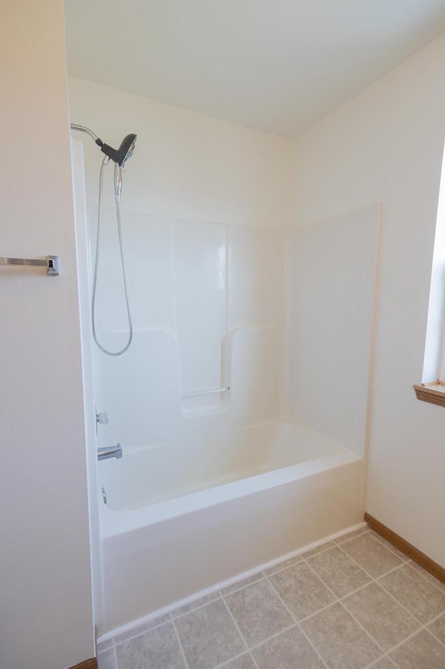 full bathroom with tile patterned floors, baseboards, and shower / bathtub combination