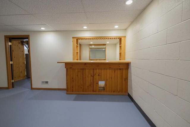 bar featuring visible vents, recessed lighting, a bar, concrete block wall, and baseboards