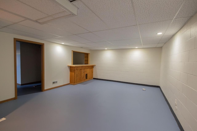 finished basement with recessed lighting, concrete block wall, baseboards, and visible vents