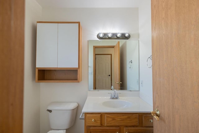 bathroom with toilet and vanity