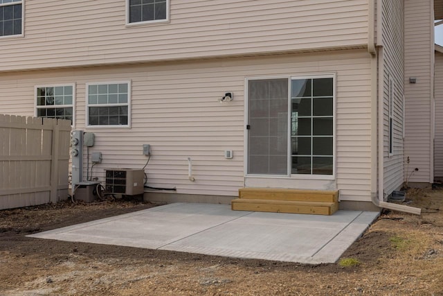 back of house featuring entry steps, a patio, fence, and central AC