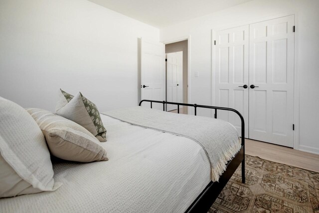 bedroom featuring wood finished floors and a closet