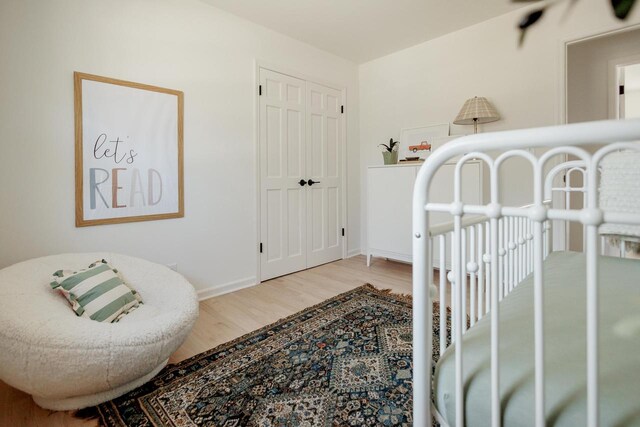 bedroom with wood finished floors and baseboards