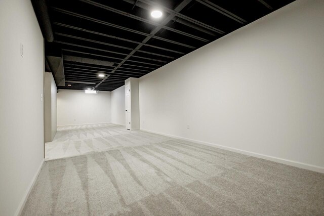 finished basement featuring baseboards and carpet floors