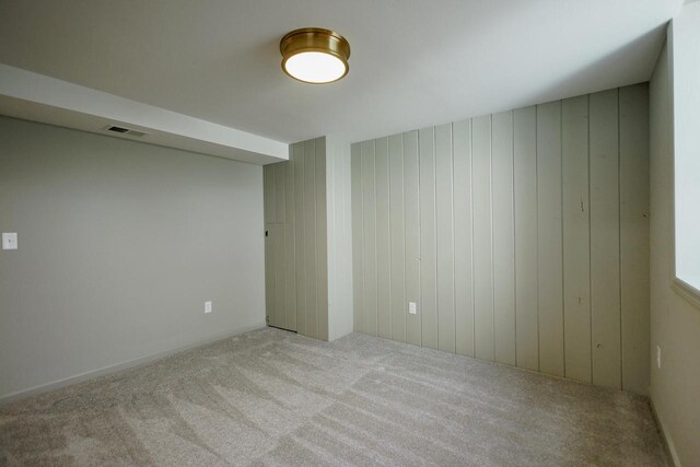 empty room with visible vents and carpet floors