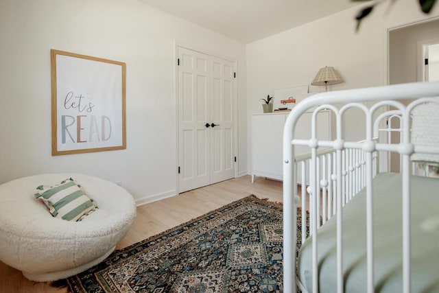 bedroom featuring baseboards and wood finished floors