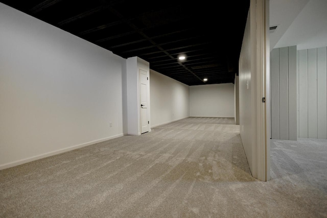 finished basement featuring baseboards and carpet