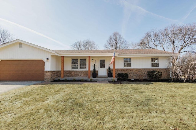 ranch-style home featuring brick siding, driveway, a front yard, and a garage