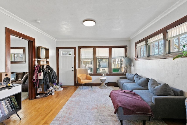 living area with crown molding and wood finished floors