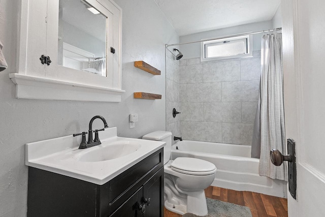 bathroom featuring vanity, wood finished floors, shower / bath combo, and toilet